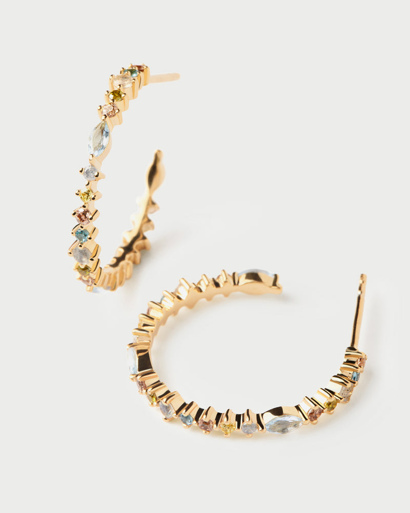 Gold-plated open hoops set with multicolor zirconia that graduate in size and shape