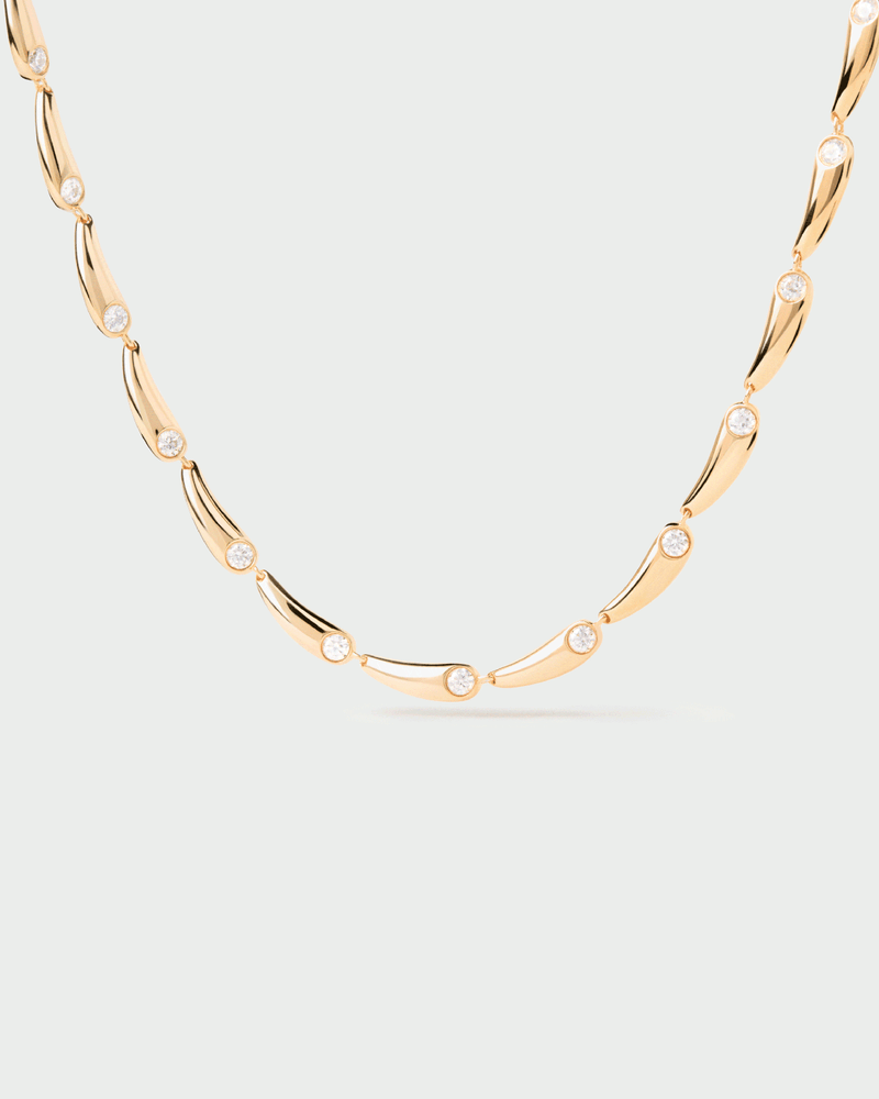 Gold-plated modern necklace with drop-shaped links accented with white zirconia