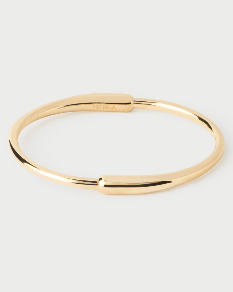 Modern bangle with asymmetric design featuring two elonganted drop-shaped motifs