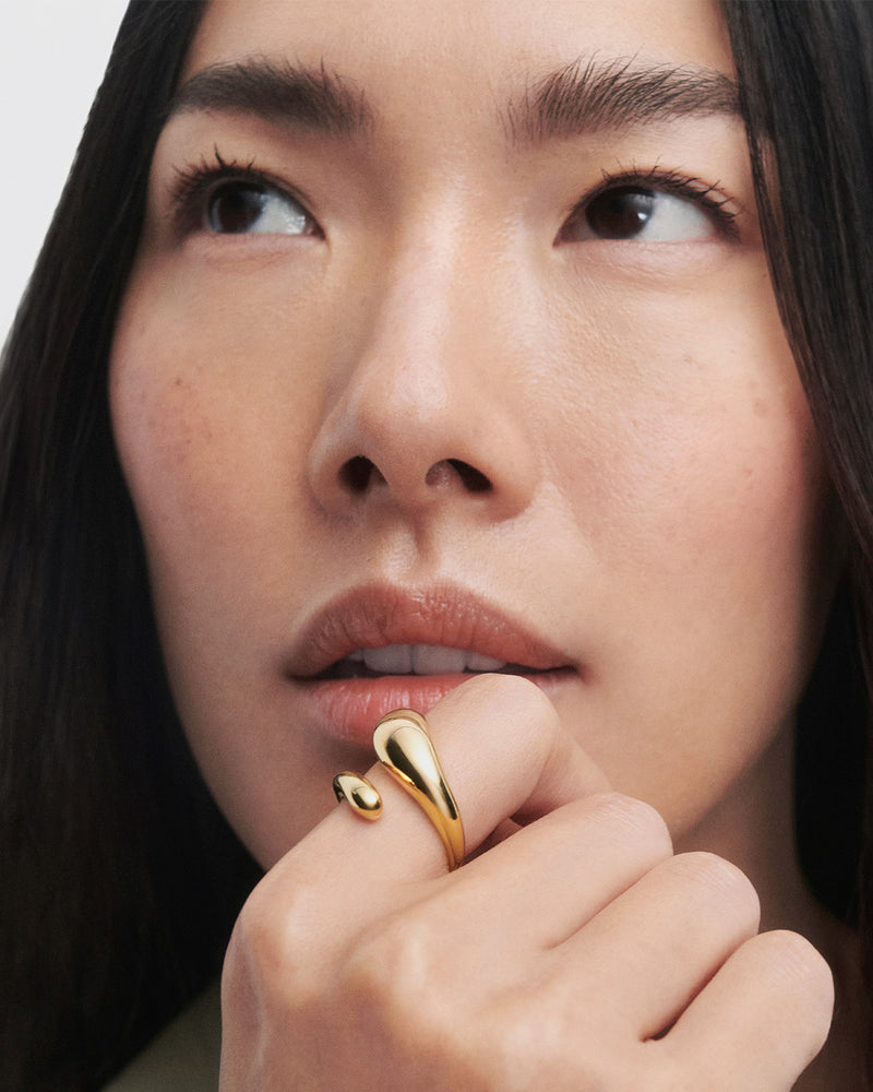 Gold-plated sculptural bypass ring with an eloganted drop shape