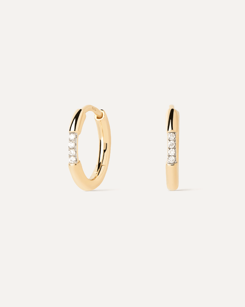 Small huggie earrings in solid yellow gold set with contrasting lab-grown diamonds