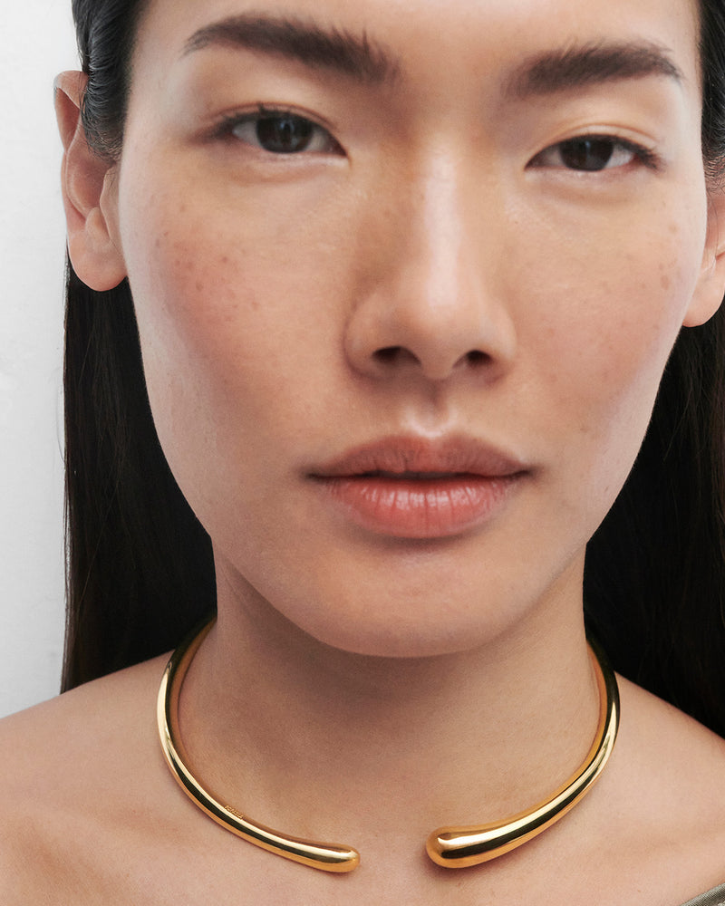 Gold-plated open choker necklace with a sculptural drop design